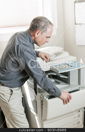 To use this stock image in your creative project, please select the size you need over to the right and click the "Add to Cart" button.
Your downloaded image will come with the Cutcaster watermark removed so don’t worry about the watermark you see on this page. Man opening photocopier in office stock photo, Business man opening photocopy machine in office by Elena Elisseeva
