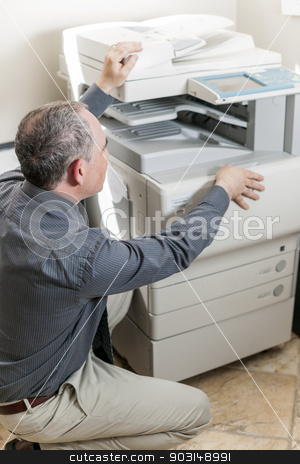 To use this stock image in your creative project, please select the size you need over to the right and click the "Add to Cart" button.
Your downloaded image will come with the Cutcaster watermark removed so don’t worry about the watermark you see on this page. Man opening photocopier in office stock photo, Business man opening photocopy machine in office by Elena Elisseeva