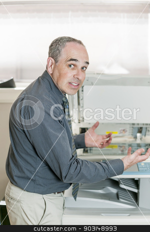 To use this stock image in your creative project, please select the size you need over to the right and click the "Add to Cart" button.
Your downloaded image will come with the Cutcaster watermark removed so don’t worry about the watermark you see on this page. Man frustrated with photocopier stock photo, Business man having problem with photocopy machine in office looking frustrated and angry by Elena Elisseeva
