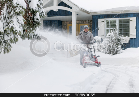 To use this stock image in your creative project, please select the size you need over to the right and click the "Add to Cart" button.
Your downloaded image will come with the Cutcaster watermark removed so don’t worry about the watermark you see on this page. Man clearing driveway with snowblower stock photo, Man using snowblower to clear deep snow on driveway near residential house after heavy snowfall. by Elena Elisseeva