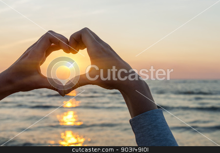 To use this stock image in your creative project, please select the size you need over to the right and click the "Add to Cart" button.
Your downloaded image will come with the Cutcaster watermark removed so don’t worry about the watermark you see on this page. Hands in heart shape framing sun stock photo, Hands and fingers in heart shape framing setting sun at sunset over ocean by Elena Elisseeva