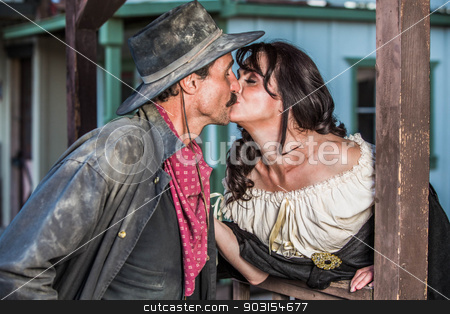 To use this stock image in your creative project, please select the size you need over to the right and click the "Add to Cart" button.
Your downloaded image will come with the Cutcaster watermark removed so don’t worry about the watermark you see on this page. Gruff Man and Woman Kiss stock photo, Portrait of an old west woman and sheriff kissing by Scott Griessel