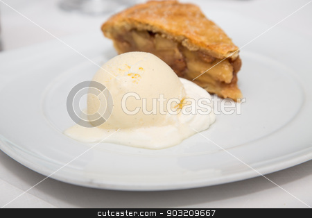 To use this stock image in your creative project, please select the size you need over to the right and click the "Add to Cart" button.
Your downloaded image will come with the Cutcaster watermark removed so don’t worry about the watermark you see on this page. Apple Pie and Vanilla Bean Ice Cream stock photo, A slice of fresh apple pie with a scoop of vanilla bean ice cream on a white plate by Darryl Brooks