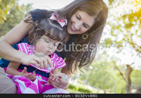 To use this stock image in your creative project, please select the size you need over to the right and click the "Add to Cart" button.
Your downloaded image will come with the Cutcaster watermark removed so don’t worry about the watermark you see on this page. Young Mother and Cute Baby Girl Applying Fingernail Polish stock photo, Mixed Race Young Mother and Cute Baby Girl Applying Fingernail Polish in the Park. by Andy Dean