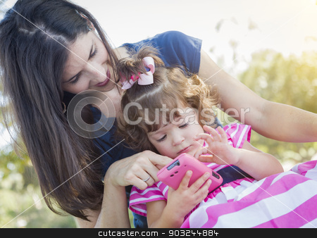 To use this stock image in your creative project, please select the size you need over to the right and click the "Add to Cart" button.
Your downloaded image will come with the Cutcaster watermark removed so don’t worry about the watermark you see on this page. Mother and Cute Baby Daughter Playing with Cell Phone stock photo, Mixed Race Mother and Cute Baby Daughter Playing with Cell Phone in Park. by Andy Dean