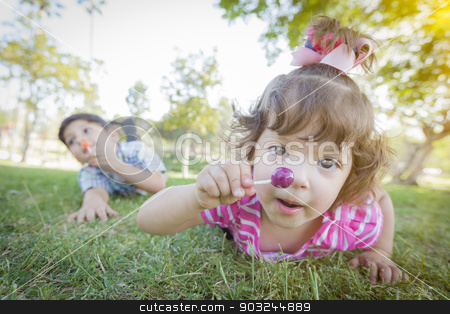 To use this stock image in your creative project, please select the size you need over to the right and click the "Add to Cart" button.
Your downloaded image will come with the Cutcaster watermark removed so don’t worry about the watermark you see on this page. Cute Baby Girl and Brother with Lollipops in Park stock photo, Cute Baby Girl and Brother with Lollipops in the Park. by Andy Dean