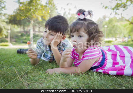 To use this stock image in your creative project, please select the size you need over to the right and click the "Add to Cart" button.
Your downloaded image will come with the Cutcaster watermark removed so don’t worry about the watermark you see on this page. Young Brother and Baby Sister Enjoying Their Lollipops Outdoors stock photo, Cute Young Brother and Baby Sister Enjoying Their Lollipops Outdoors on the Grass. by Andy Dean