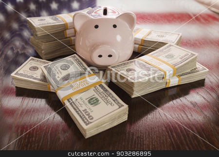 To use this stock image in your creative project, please select the size you need over to the right and click the "Add to Cart" button.
Your downloaded image will come with the Cutcaster watermark removed so don’t worry about the watermark you see on this page. Thousands of Dollars, Piggy Bank, American Flag Reflection on Ta stock photo, Thousands of Dollars and Piggy Bank with Reflection of American Flag on Table. by Andy Dean