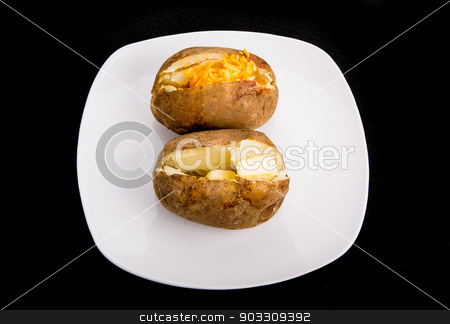 To use this stock image in your creative project, please select the size you need over to the right and click the "Add to Cart" button.
Your downloaded image will come with the Cutcaster watermark removed so don’t worry about the watermark you see on this page. Two Baked Potatoes with Butter and Cheese stock photo, Two baked potatoes on a white plate and black background. One with butter and one with cheese by Darryl Brooks