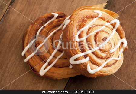 To use this stock image in your creative project, please select the size you need over to the right and click the "Add to Cart" button.
Your downloaded image will come with the Cutcaster watermark removed so don’t worry about the watermark you see on this page. Freshly baked flaky Danish pastries stock photo, Freshly baked spiral Danish pastries with flaky puff pastry filled with apple or almond paste and drizzled with white icing for a delicious sticky sweet snack or dessert by Stephen Gibson