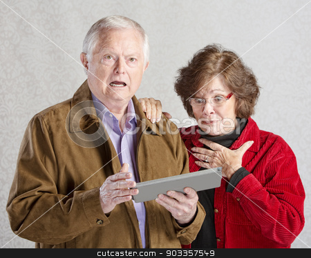 To use this stock image in your creative project, please select the size you need over to the right and click the "Add to Cart" button.
Your downloaded image will come with the Cutcaster watermark removed so don’t worry about the watermark you see on this page. Startled Couple with Tablet stock photo, Startled man and woman looking at computer tablet by Scott Griessel
