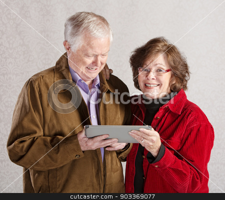 To use this stock image in your creative project, please select the size you need over to the right and click the "Add to Cart" button.
Your downloaded image will come with the Cutcaster watermark removed so don’t worry about the watermark you see on this page. Happy Couple with Tablet stock photo, Happy older man and woman holding a tablet computer by Scott Griessel