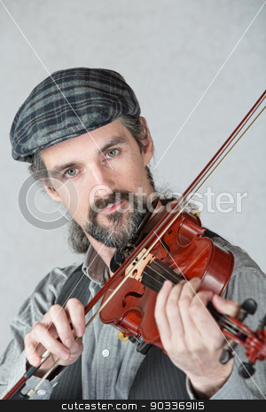 To use this stock image in your creative project, please select the size you need over to the right and click the "Add to Cart" button.
Your downloaded image will come with the Cutcaster watermark removed so don’t worry about the watermark you see on this page. Irish Man Playing Fiddle stock photo, Serious Irish man playing a fiddle over gray background by Scott Griessel