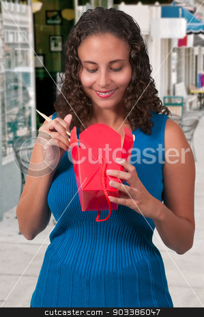 To use this stock image in your creative project, please select the size you need over to the right and click the "Add to Cart" button.
Your downloaded image will come with the Cutcaster watermark removed so don’t worry about the watermark you see on this page. Woman Eating stock photo, Beautiful woman eating Chinese Japanese or Asian takeout food by Robert Byron