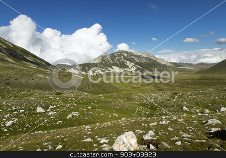 To use this stock image in your creative project, please select the size you need over to the right and click the "Add to Cart" button.
Your downloaded image will come with the Cutcaster watermark removed so don’t worry about the watermark you see on this page. one stone stock photo, beautiful mountain view and blue cloudy sky by metrue