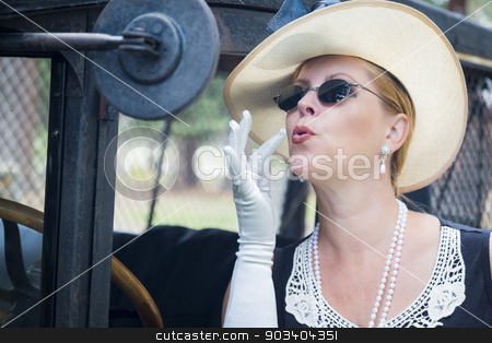 To use this stock image in your creative project, please select the size you need over to the right and click the "Add to Cart" button.
Your downloaded image will come with the Cutcaster watermark removed so don’t worry about the watermark you see on this page. Attractive Woman in Twenties Outfit Checking Makeup in Antique A stock photo, Attractive Young Woman in Twenties Outfit Checking Makeup in Antique Automobile. by Andy Dean