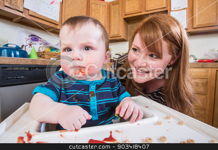 To use this stock image in your creative project, please select the size you need over to the right and click the "Add to Cart" button.
Your downloaded image will come with the Cutcaster watermark removed so don’t worry about the watermark you see on this page. Woman Feeds Baby in Kitchen stock photo, A woman feeds her baby breakfast in the kitchen by Scott Griessel