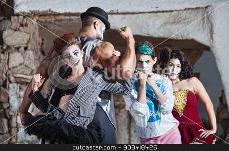 To use this stock image in your creative project, please select the size you need over to the right and click the "Add to Cart" button.
Your downloaded image will come with the Cutcaster watermark removed so don’t worry about the watermark you see on this page. Bizarre Cirque Performance stock photo, Bizarre comedia del arte performance ensemble outdoors by Scott Griessel
