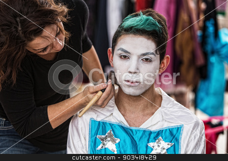 To use this stock image in your creative project, please select the size you need over to the right and click the "Add to Cart" button.
Your downloaded image will come with the Cutcaster watermark removed so don’t worry about the watermark you see on this page. Woman Brushing Makeup on Clown stock photo, Makeup artist brushing white on serious young cirque performer by Scott Griessel