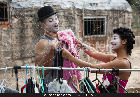To use this stock image in your creative project, please select the size you need over to the right and click the "Add to Cart" button.
Your downloaded image will come with the Cutcaster watermark removed so don’t worry about the watermark you see on this page. Cirque Clowns Fitting Costumes stock photo, Two laughing cirque clowns fitting costumes outdoors by Scott Griessel