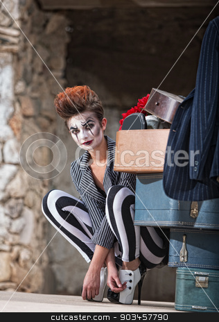 To use this stock image in your creative project, please select the size you need over to the right and click the "Add to Cart" button.
Your downloaded image will come with the Cutcaster watermark removed so don’t worry about the watermark you see on this page. Clown Near Luggage stock photo, Cute female comedia del arte performer next to luggage by Scott Griessel