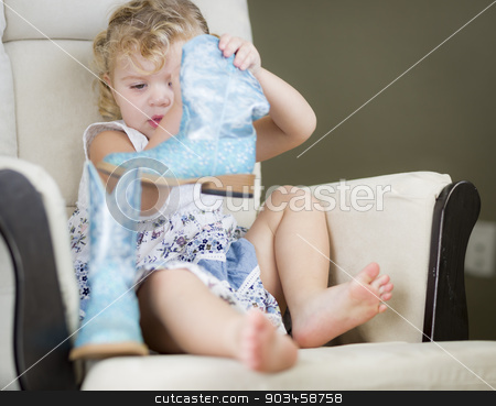 To use this stock image in your creative project, please select the size you need over to the right and click the "Add to Cart" button.
Your downloaded image will come with the Cutcaster watermark removed so don’t worry about the watermark you see on this page. Blonde Haired Blue Eyed Little Girl Putting on Cowboy Boots stock photo, Adorable Blonde Haired Blue Eyed Little Girl Putting on Cowboy Boots. by Andy Dean