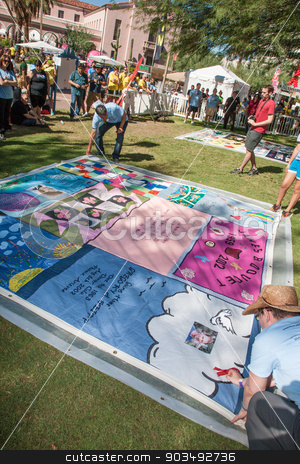 To use this stock image in your creative project, please select the size you need over to the right and click the "Add to Cart" button.
Your downloaded image will come with the Cutcaster watermark removed so don’t worry about the watermark you see on this page. Revealing Section of AIDS Quilt at ceremony stock photo, TUCSON, AZ/USA - OCTOBER 12: Unidentifed people at AIDS Quilt Ceremony on October 12, 2014 in Tucson, Arizona, USA. by Scott Griessel