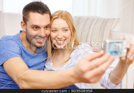 To use this stock image in your creative project, please select the size you need over to the right and click the "Add to Cart" button.
Your downloaded image will come with the Cutcaster watermark removed so don’t worry about the watermark you see on this page. smiling couple taking picture with digital camera stock photo, love, family, technology and happiness concept - smiling couple taking self portrait picture with digital camera at home by Syda Productions