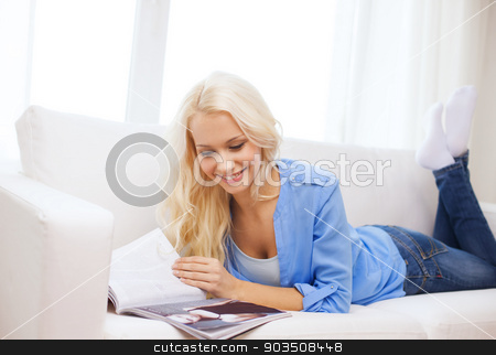 To use this stock image in your creative project, please select the size you need over to the right and click the "Add to Cart" button.
Your downloaded image will come with the Cutcaster watermark removed so don’t worry about the watermark you see on this page. woman lying on couch and reading magazine at home stock photo, home and leasure concept - smiling woman lying on couch and reading magazine at home by Syda Productions