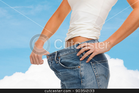 To use this stock image in your creative project, please select the size you need over to the right and click the "Add to Cart" button.
Your downloaded image will come with the Cutcaster watermark removed so don’t worry about the watermark you see on this page. close up of female showing big jeans stock photo, healthcare, diet and fitness concept - close up of female showing big jeans by Syda Productions