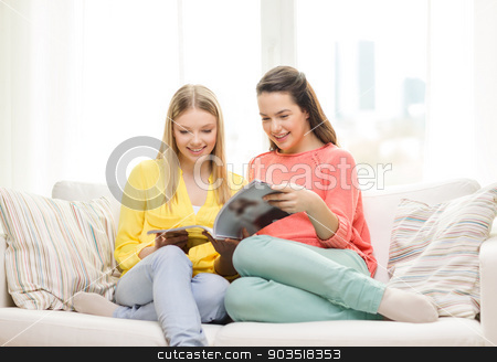 To use this stock image in your creative project, please select the size you need over to the right and click the "Add to Cart" button.
Your downloaded image will come with the Cutcaster watermark removed so don’t worry about the watermark you see on this page. two girlfriends reading magazine at home stock photo, friendship and happiness concept - two girlfriends reading magazine at home by Syda Productions