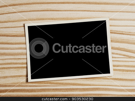 To use this stock image in your creative project, please select the size you need over to the right and click the "Add to Cart" button.
Your downloaded image will come with the Cutcaster watermark removed so don’t worry about the watermark you see on this page. Old photograph. stock photo, Old blank photograph on wooden table. by Pablo Caridad