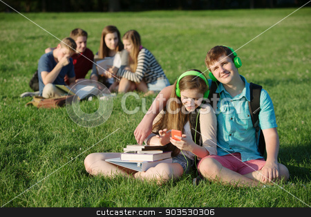 To use this stock image in your creative project, please select the size you need over to the right and click the "Add to Cart" button.
Your downloaded image will come with the Cutcaster watermark removed so don’t worry about the watermark you see on this page. Cute Teen Couple with Headphones stock photo, Cute student teen couple listening to music outdoors by Scott Griessel