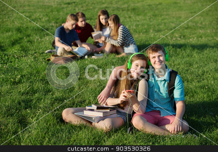 To use this stock image in your creative project, please select the size you need over to the right and click the "Add to Cart" button.
Your downloaded image will come with the Cutcaster watermark removed so don’t worry about the watermark you see on this page. Teen Couple Sitting Outdoors stock photo, Cheerful European couple with earphones and cell phone outdoors by Scott Griessel