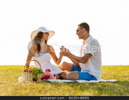 To use this stock image in your creative project, please select the size you need over to the right and click the "Add to Cart" button.
Your downloaded image will come with the Cutcaster watermark removed so don’t worry about the watermark you see on this page. smiling couple with small red gift box on picnic stock photo, love, dating, people and holidays concept - smiling young man showing small red gift box to his girlfriend on picnic by Syda Productions