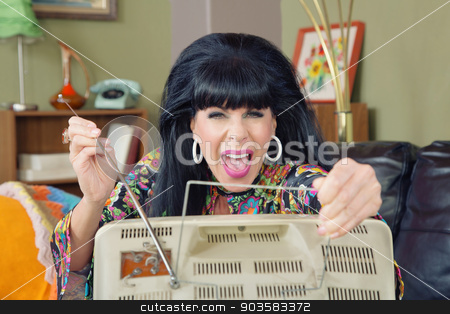 To use this stock image in your creative project, please select the size you need over to the right and click the "Add to Cart" button.
Your downloaded image will come with the Cutcaster watermark removed so don’t worry about the watermark you see on this page. Lady Adjusting TV Antenna stock photo, Excited retro 1960s woman adjusting antenna on TV by Scott Griessel