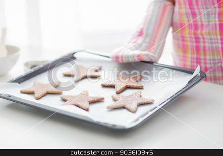 To use this stock image in your creative project, please select the size you need over to the right and click the "Add to Cart" button.
Your downloaded image will come with the Cutcaster watermark removed so don’t worry about the watermark you see on this page. close up of woman with cookies on oven tray stock photo, christmas, food, holidays and people concept - close up of woman in apron and oven glove with cookies on oven tray by Syda Productions