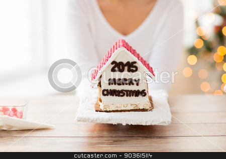 To use this stock image in your creative project, please select the size you need over to the right and click the "Add to Cart" button.
Your downloaded image will come with the Cutcaster watermark removed so don’t worry about the watermark you see on this page. close up of woman showing gingerbread house stock photo, cooking, people, christmas and baking concept - close up of happy woman holding and showing gingerbread house at home by Syda Productions
