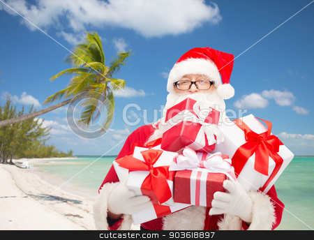 To use this stock image in your creative project, please select the size you need over to the right and click the "Add to Cart" button.
Your downloaded image will come with the Cutcaster watermark removed so don’t worry about the watermark you see on this page. man in costume of santa claus with gift boxes stock photo, christmas, holidays and people concept - man in costume of santa claus with gift boxes over tropical beach background by Syda Productions