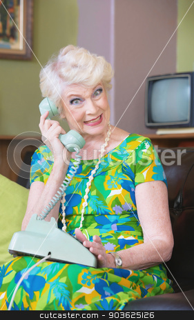 To use this stock image in your creative project, please select the size you need over to the right and click the "Add to Cart" button.
Your downloaded image will come with the Cutcaster watermark removed so don’t worry about the watermark you see on this page. Smiling Woman on Phone stock photo, Happy senior woman in green on rotary telephone by Scott Griessel