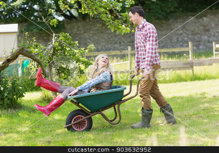To use this stock image in your creative project, please select the size you need over to the right and click the "Add to Cart" button.
Your downloaded image will come with the Cutcaster watermark removed so don’t worry about the watermark you see on this page. Handsome man pushing his laughing girlfriend in a wheelbarrow stock photo, Handsome man pushing his laughing girlfriend in a wheelbarrow in a sunny garden by Wavebreak Media