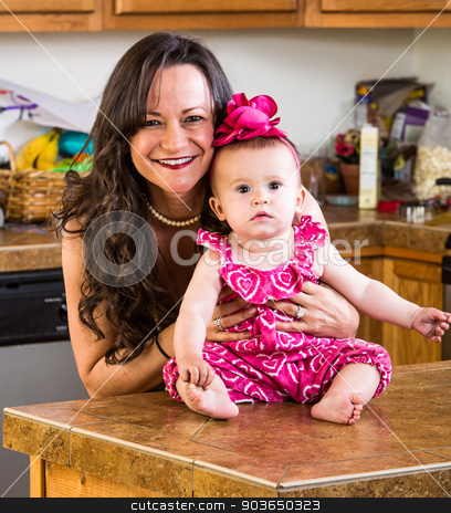 To use this stock image in your creative project, please select the size you need over to the right and click the "Add to Cart" button.
Your downloaded image will come with the Cutcaster watermark removed so don’t worry about the watermark you see on this page. Mother Poses With Her Baby stock photo, A mother in the kitchen poses with her baby by Scott Griessel