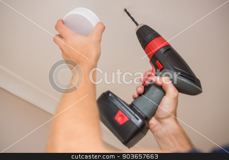 To use this stock image in your creative project, please select the size you need over to the right and click the "Add to Cart" button.
Your downloaded image will come with the Cutcaster watermark removed so don’t worry about the watermark you see on this page. Handyman installing smoke detector stock photo, Handyman installing smoke detector with power tool on the ceiling by Wavebreak Media