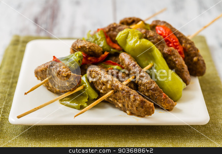 To use this stock image in your creative project, please select the size you need over to the right and click the "Add to Cart" button.
Your downloaded image will come with the Cutcaster watermark removed so don’t worry about the watermark you see on this page. Meat Ball at Shish stock photo, Meat ball, green pepper, tomato at shish in ceramic white plate by OZMedia