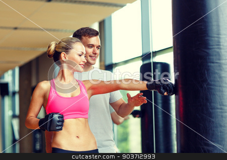 To use this stock image in your creative project, please select the size you need over to the right and click the "Add to Cart" button.
Your downloaded image will come with the Cutcaster watermark removed so don’t worry about the watermark you see on this page. smiling woman with personal trainer boxing in gym stock photo, sport, fitness, lifestyle and people concept - smiling woman with personal trainer boxing in gym by Syda Productions