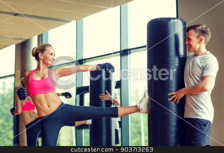 To use this stock image in your creative project, please select the size you need over to the right and click the "Add to Cart" button.
Your downloaded image will come with the Cutcaster watermark removed so don’t worry about the watermark you see on this page. smiling woman with personal trainer boxing in gym stock photo, sport, fitness, lifestyle and people concept - smiling woman with personal trainer boxing in gym by Syda Productions