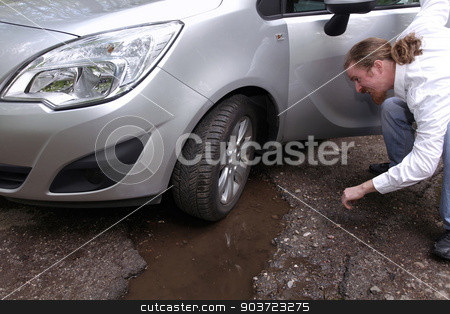To use this stock image in your creative project, please select the size you need over to the right and click the "Add to Cart" button.
Your downloaded image will come with the Cutcaster watermark removed so don’t worry about the watermark you see on this page. Upset driver man in front of automobile watching damaged car of stock photo, Upset driver man in front of automobile watching damaged car of road full of cracked potholes in pavement by vladacanon1