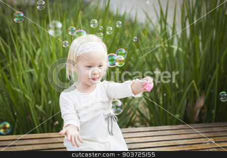 To use this stock image in your creative project, please select the size you need over to the right and click the "Add to Cart" button.
Your downloaded image will come with the Cutcaster watermark removed so don’t worry about the watermark you see on this page. Adorable Little Girl Having Fun With Bubbles stock photo, Adorable Little Girl Sitting On Bench Having Fun With Bubbles Outside. by Andy Dean