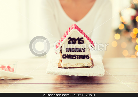 To use this stock image in your creative project, please select the size you need over to the right and click the "Add to Cart" button.
Your downloaded image will come with the Cutcaster watermark removed so don’t worry about the watermark you see on this page. close up of woman showing gingerbread house stock photo, cooking, people, christmas and baking concept - close up of happy woman holding and showing gingerbread house at home by Syda Productions