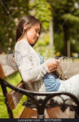 To use this stock image in your creative project, please select the size you need over to the right and click the "Add to Cart" button.
Your downloaded image will come with the Cutcaster watermark removed so don’t worry about the watermark you see on this page. Smiling student sitting on bench text message on her mobile phon stock photo, Smiling student sitting on bench text message on her mobile phone in park at school by Wavebreak Media